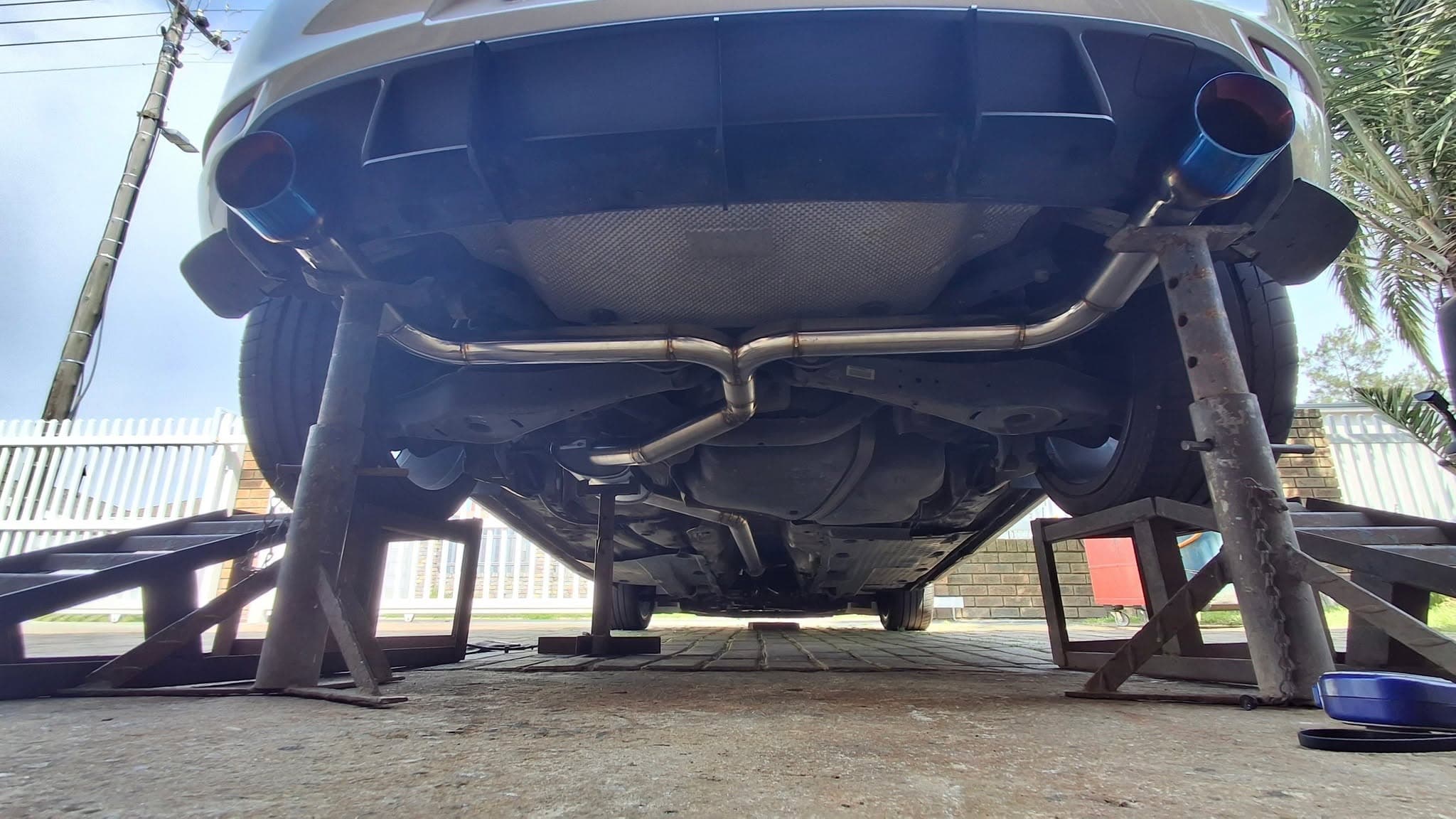 Stainless exhaust system installed beneath a Volkswagen Golf GTI Mk6